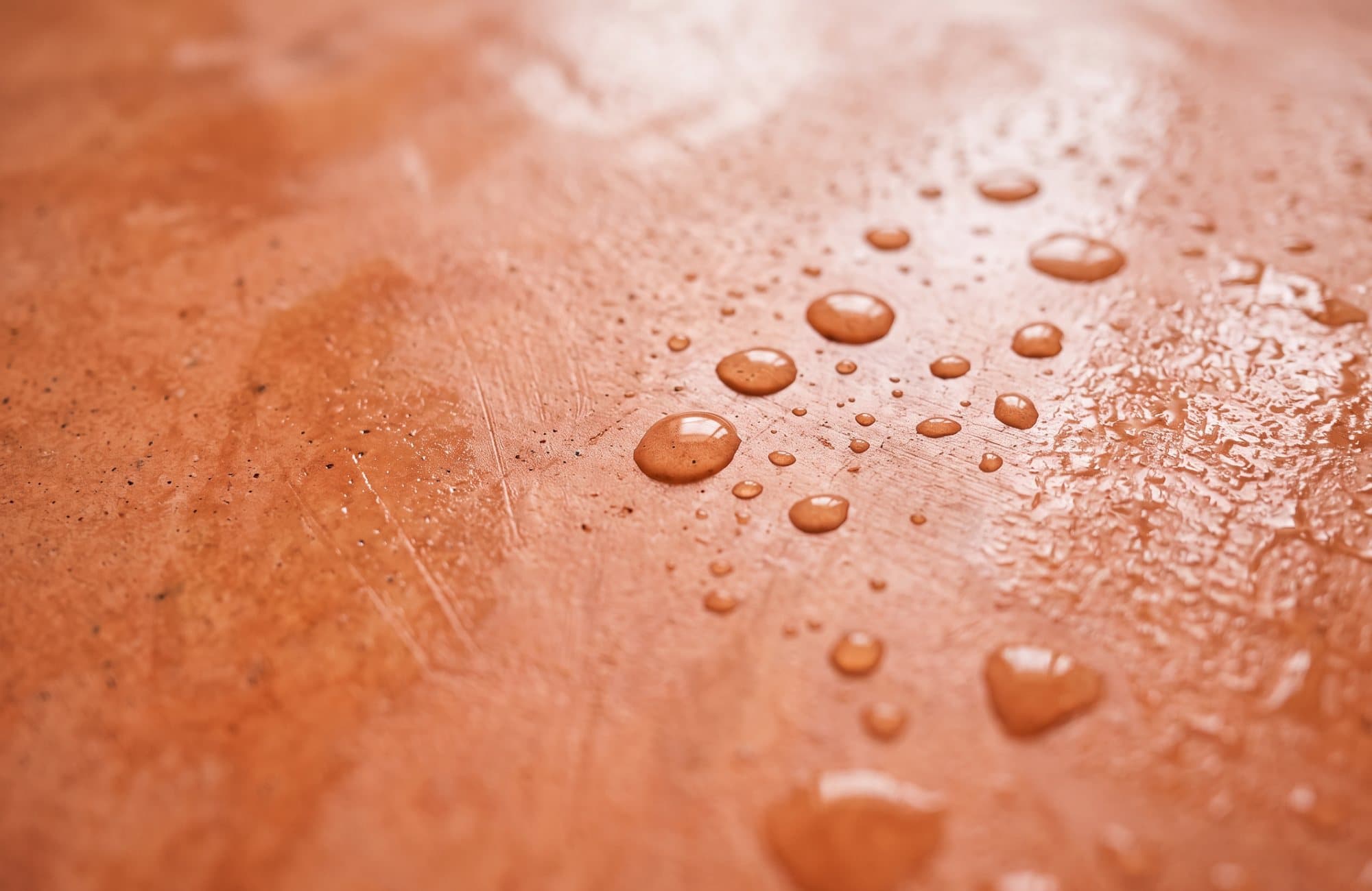 Water beading on polished terracotta tadelakt